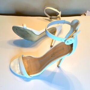 White high heeled Seletto Sandals in a 4.75 inch heel with ankle buckle strap.